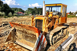 Yellow bulldozer in cleared construction site
