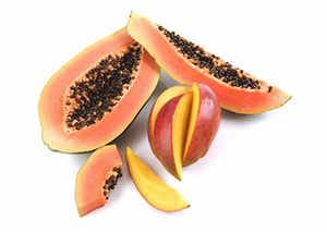 colorful papaya fruit cut open to show hundreds of small black seeds