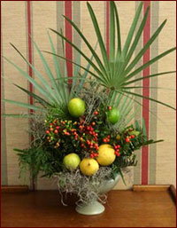 Natural holiday arrangement with citrus and palm fronds