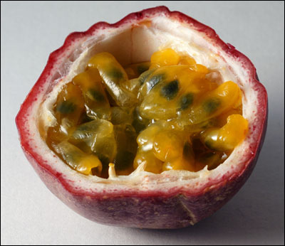 A passion fruit open to show seeds