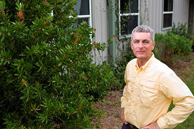 Dr. Edward Gilman standing next to healthy shrubs
