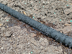 Black foam hose with water seeping out of it