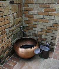 A beautiful copper hose storage pot
