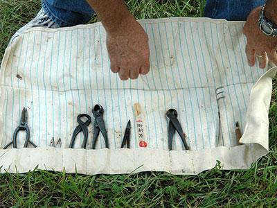 A gardener rolls his tools out on the grass