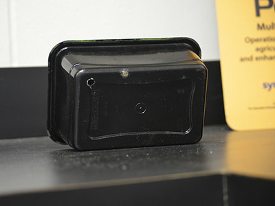 Dark container with hole in bottom