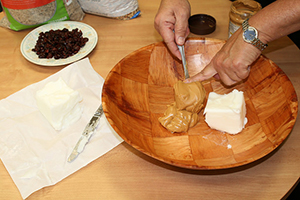 Mixing peanut butter and lard in a bowl