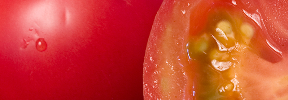 Macro view of a red tomatoes, one cut open