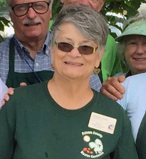 Cheryl Owen with short gray hair, sunglasses, and a green shirt