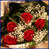 A bouquet of red roses with white baby's breath
