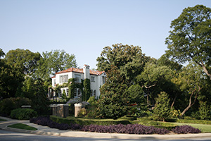 A large home landscape with trees.