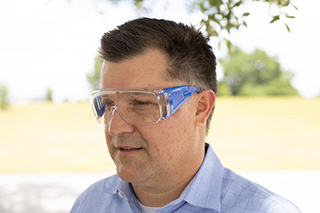 Man wearing clear protective eye wear